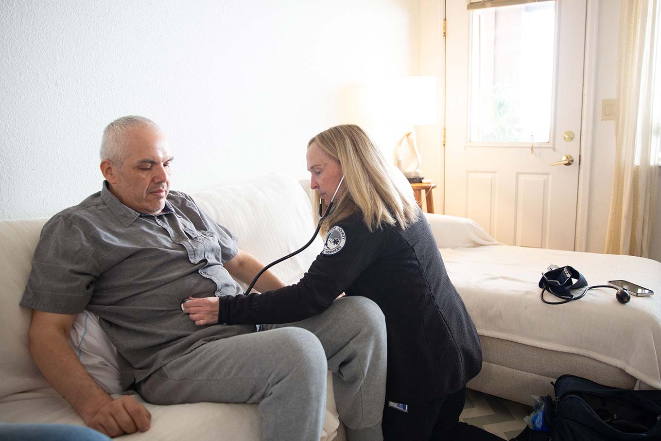 Home health nurse Donna Frimston listens to Abraham Torres Razo's heartbeat with a stethoscope during a home visit in Avon, Colorado.