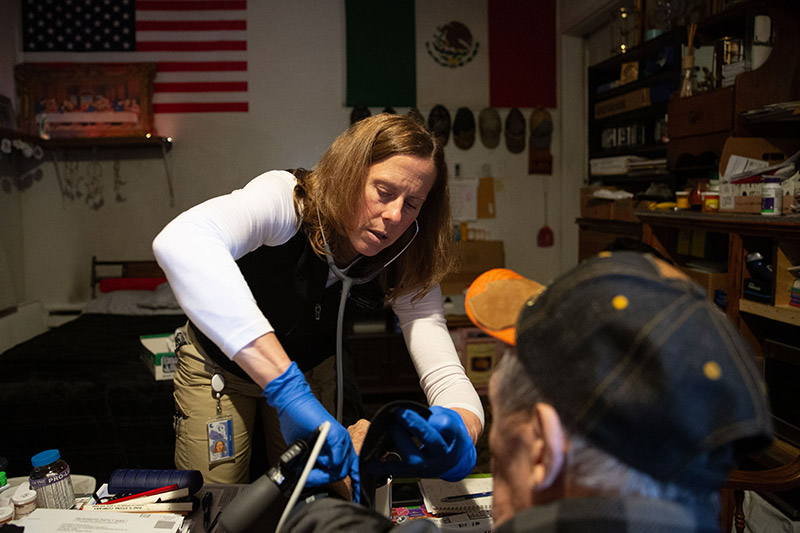Home health nurse Rachel Van Sloun checks a patient's vitals during a home visit in Dotsero, Colorado.