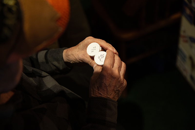 Home health nurse Rachel Van Sloun helps patient Kevin Kanne review his medication schedule during a home visit in Dotsero, Colorado.