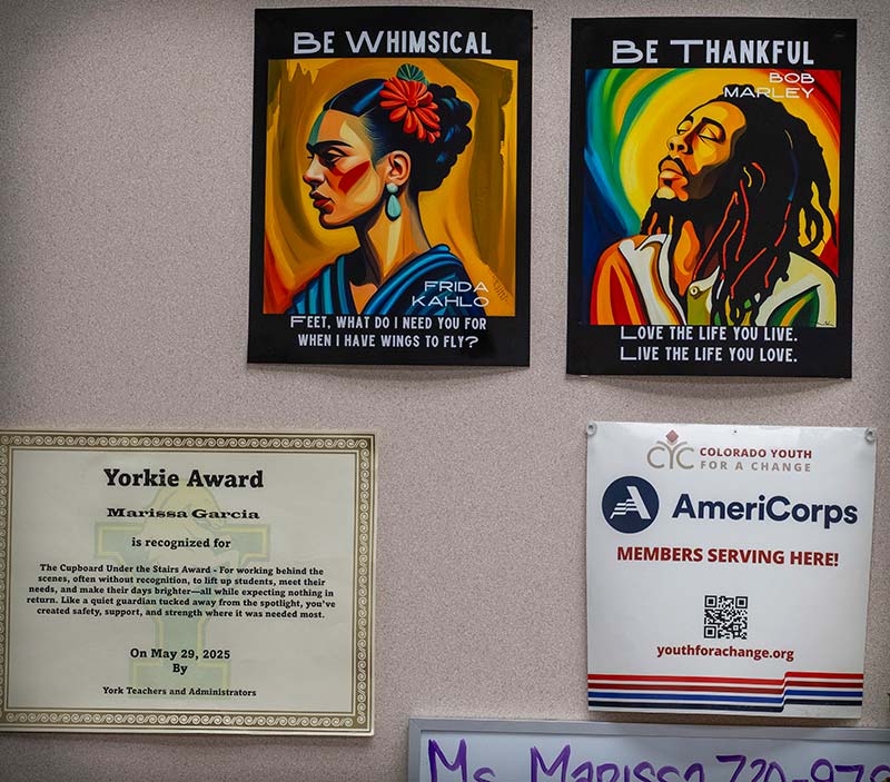 A wall display featuring inspirational posters, a "Yorkie Award" certificate for Marissa Garcia, and an AmeriCorps sign.